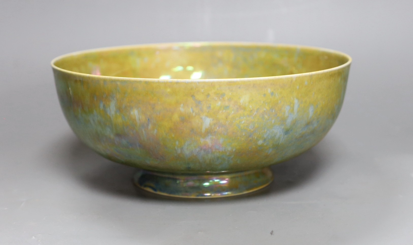 A Ruskin thinly potted green and ochre lustre fruit bowl, dated 1923, 25cm diameter